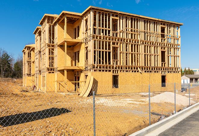 a close-up of temporary chain link fences enclosing a job site, signaling progress in the project's development in Portola Valley